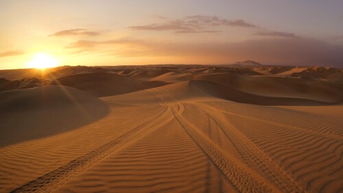 Desert-with-dune-buggy-tires-tracks-in-the-sand-Huacachina-Ica-Peru.jpg