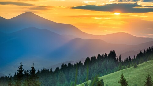 Dramatic-sunset-over-mountains-landscape-with-sun-shining-through-orange-clouds.jpg