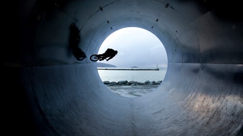 Man-riding-bmx-bike-in-tunnel-Trondheim-Norway.jpg