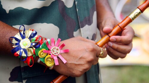 Officer-wearing-a-rakhi-on-his-wrist-during-rakshabandhan.jpg