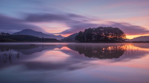 Pine-tree-island-reflection-in-water-at-dawn-Vietnam.jpg