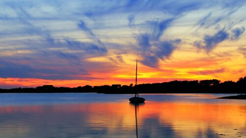 Sunset-and-sailboat-in-Marthas-Vineyard-Massachusetts-USA.jpg